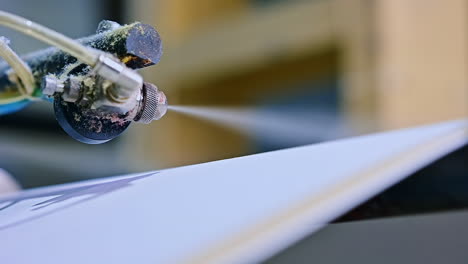 diapers manufacturing plant. special mechanism spraying the layer. close up.