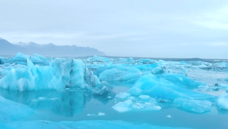 Aerial-forward-view-of-lake-with-blocks-of-ice,-in-a-surreal-environment