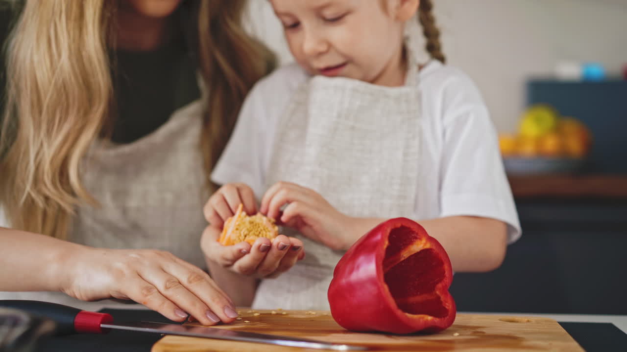 woman with playful daughter takes away seeds from board