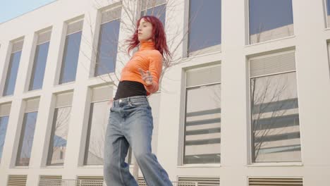 young urban dancer performing outside modern building