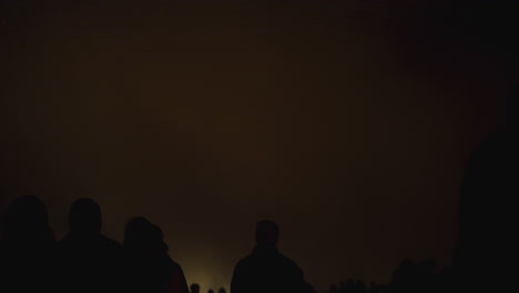 exploding fireworks create a veil of smoke that flashes as it reflects the light of the bright rockets and enchanting fireworks display