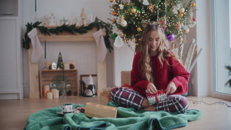 beautiful woman wrapping christmas gifts at home