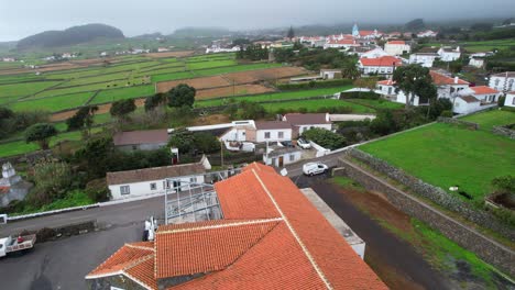 Aerial-shot-over-a-red-tiled-roof-with-a-part-under-maintenance