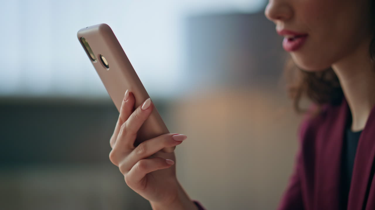 Freelancer hands scrolling smartphone in home office. Relaxed girl browsing web