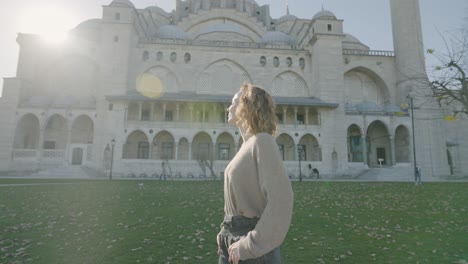 woman in front of a mosque