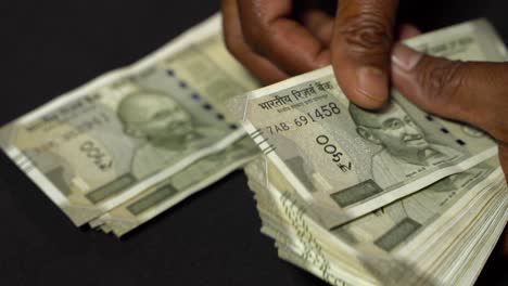 a man counting indian rupees