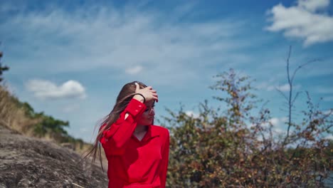 woman posing on nature. beauty woman in red dress outdoor