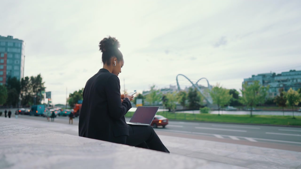 Young Professional Woman Using Smartphone Outdoors in City