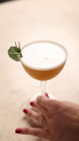 woman holding a cocktail