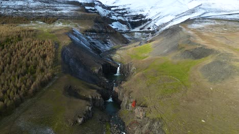 beautiful landscape of stacked double waterfalls on iceland mountainside, aerial