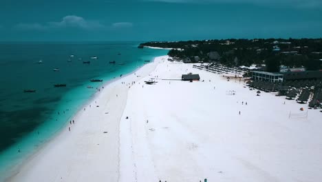 Perfect-aerial-flight-slowly-sinking-down-drone-shot-on-dream-white-sand-beach-and-turquoise-water