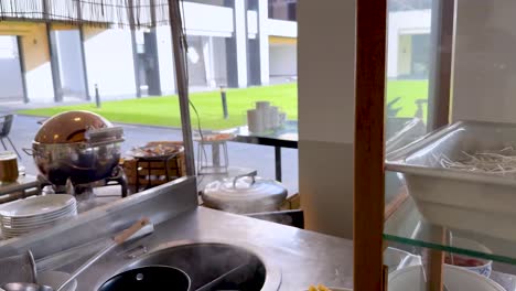 preparing noodles at a bangkok food stall