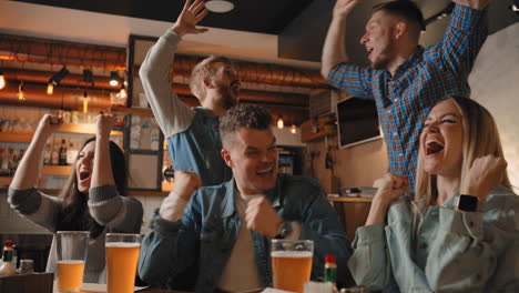 soccer fans celebrating victory of team in sports bar. sport fans watch tv game. loyal football fans supporting their team