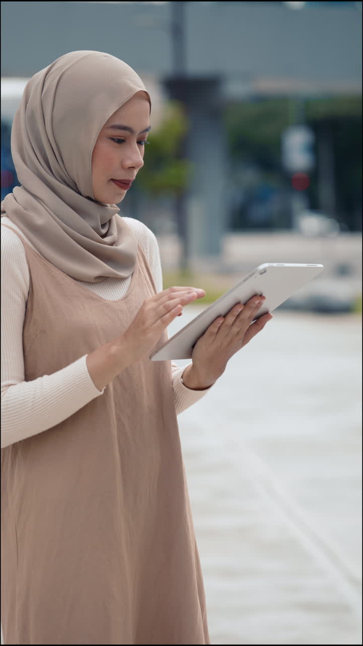 Woman in hijab using a tablet