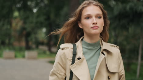 Caucasian-female-student-walking-outdoors.