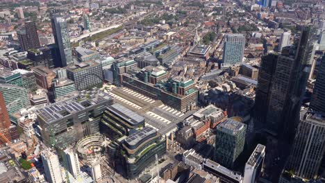 aerial view of broadgate and liverpool street station, including a close up of the city of london towers, london, uk