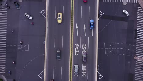 Busy-roads-intersection-from-above,-revealing-cars-and-buses-driving-through-the-city