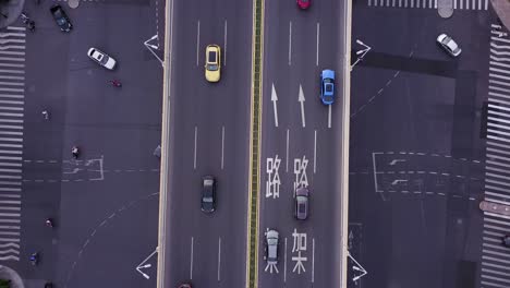 busy roads intersection from above, revealing cars and buses driving through the city