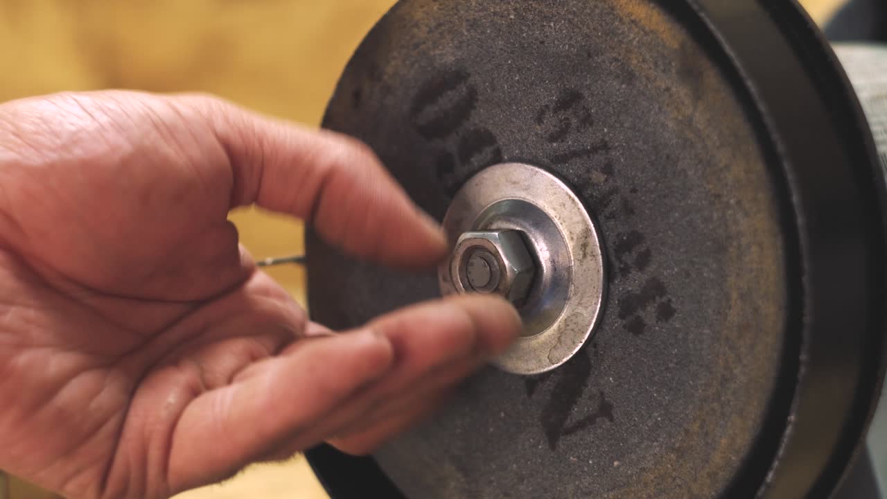 Male hand tightening a nut