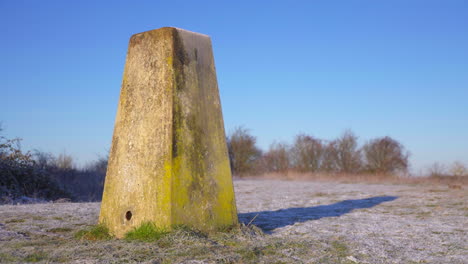 Close-up-of-winter-heavy-frost-on-marker-stone-low-sun-day-4K