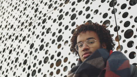 young man in front of modern building