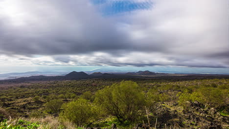 View-of-the-south-eastern-crater-of-volcano-Etna-visible-in-a-distance-in-Sicily,-Italy-with-dark-clouds-movement-in-timelapse