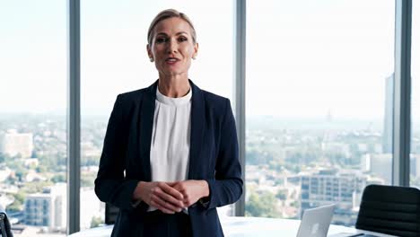 portrait of a confident blonde businesswoman in a modern high-rise office