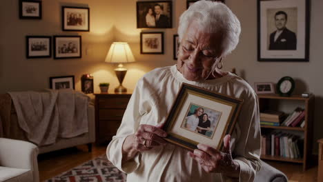 senior woman looking at a family photo