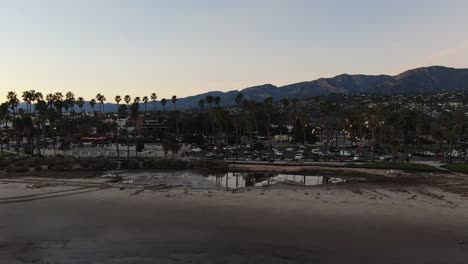 Aerial-shot-descending-on-the-beach-and-pier-on-the-beach-in-California