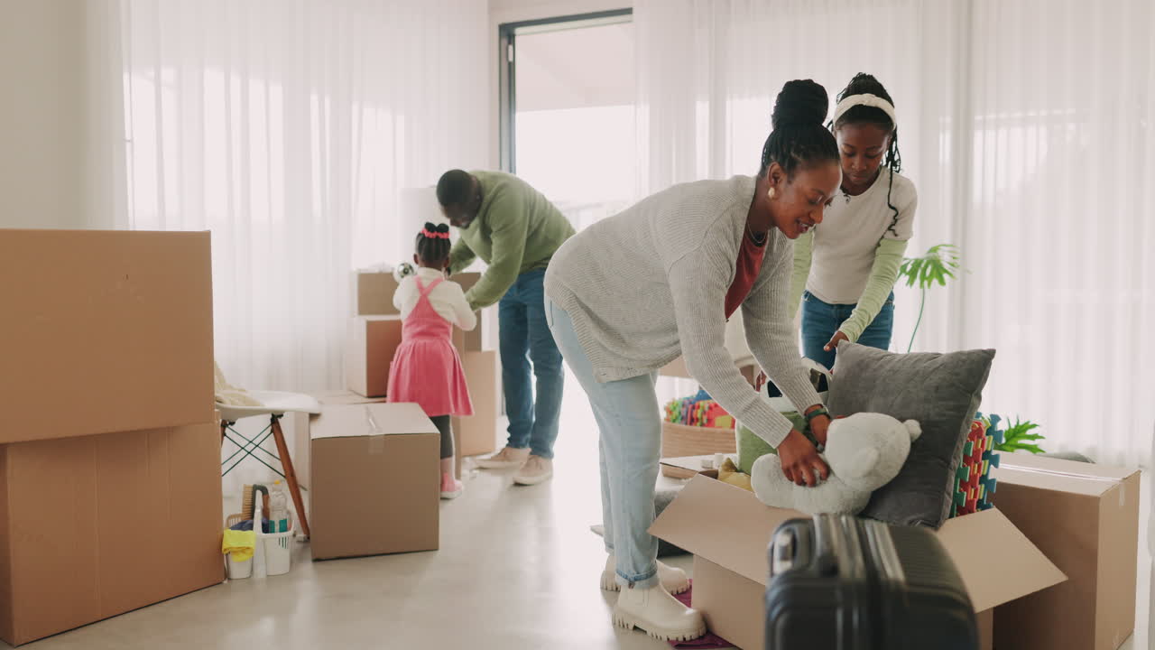 New home, parents or children packing boxes as