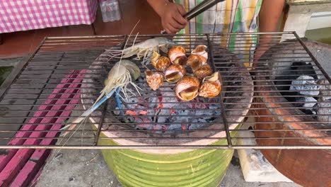 grilling seafood on an open charcoal grill