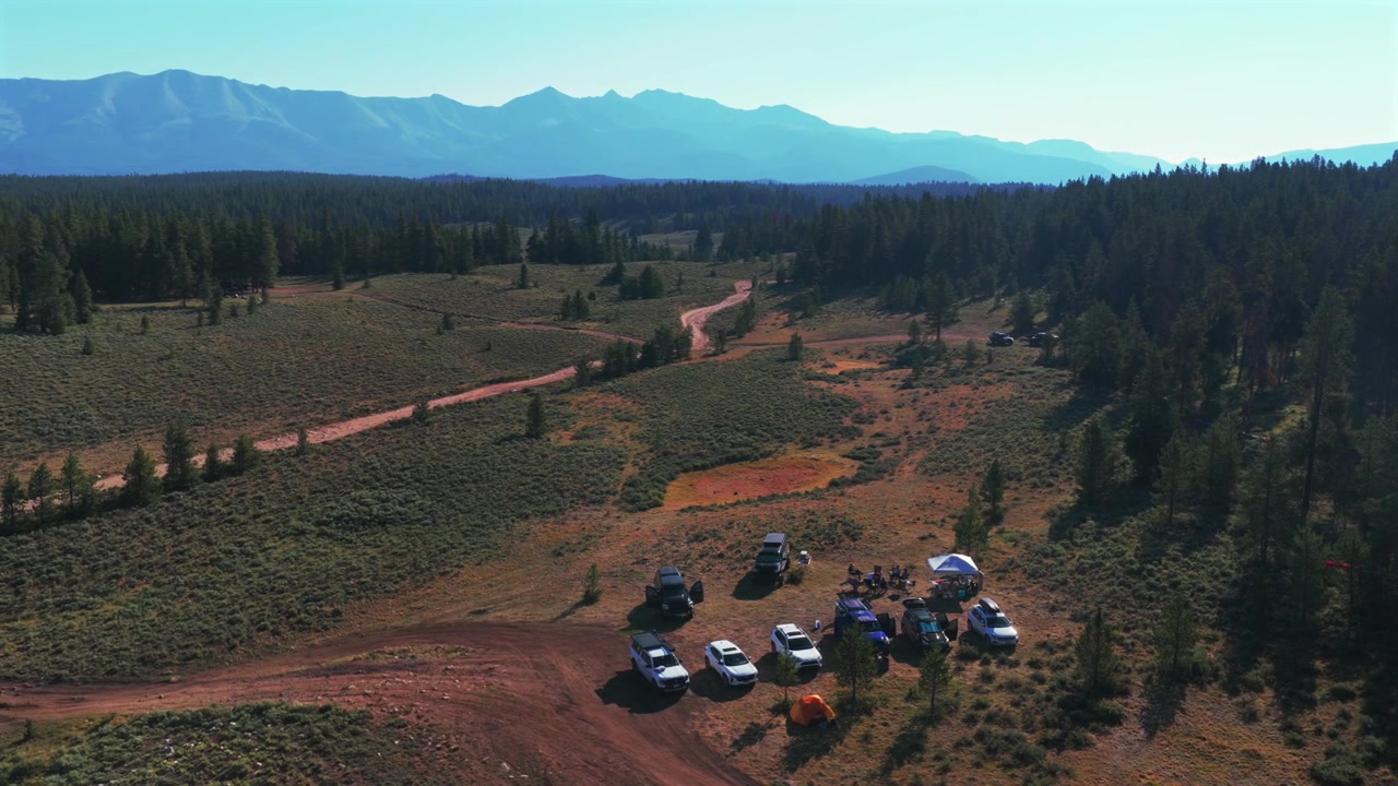 Ripresa aerea con drone del Taylor Park Reservoir, Lakeview Campground, campeggio Rivers End, Colorado. Monte Columbia, Collegiate Peaks, Sawatch Range, Contea di Gunnison. Mattinata estiva soleggiata con foschia e cieli blu, il drone gira a destra.