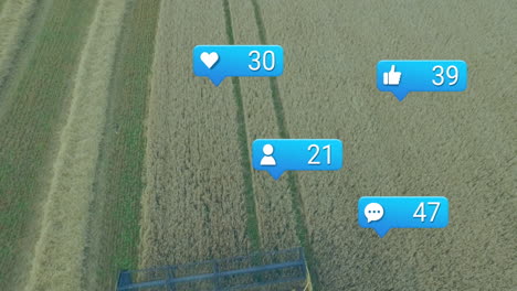 drone capturing animation of social media icons over wheat field in countryside