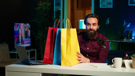 excited media star holding colorful shopping bags