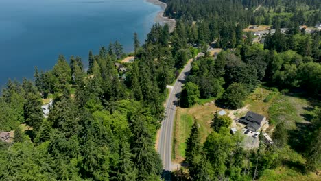 drone shot of a road running parallel to the freeland, washington shoreline