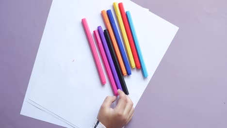 top view of child hand pick  pencil