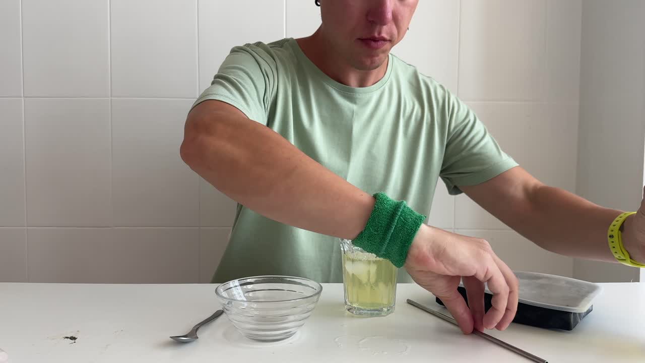 Man Preparing and Drinking a Refreshing Cold Beverage