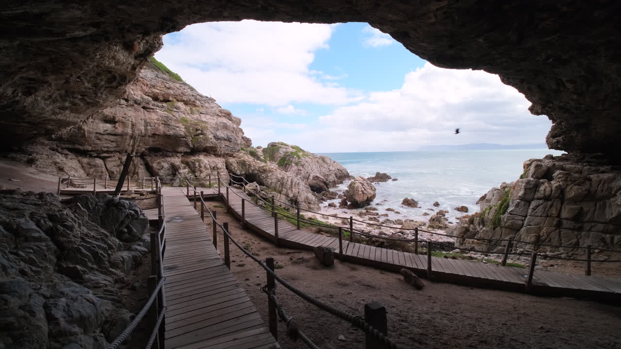 Wooden walkway inside historic Klipgat Cave on Die Plaat coastline, Walker Bay