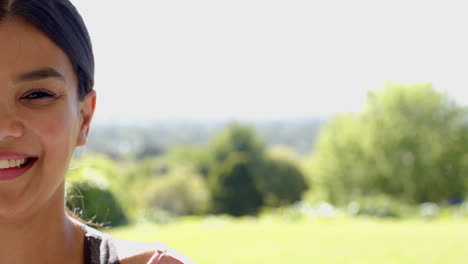 smiling girl enjoying sunny day in lush green park, feeling joyful outdoors, copy space
