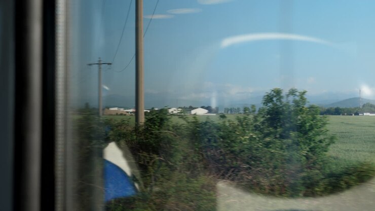 a view from the train heading to a mountain