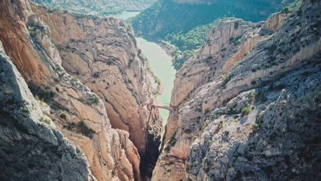 narrow bridge between two steep mountains over the canyon