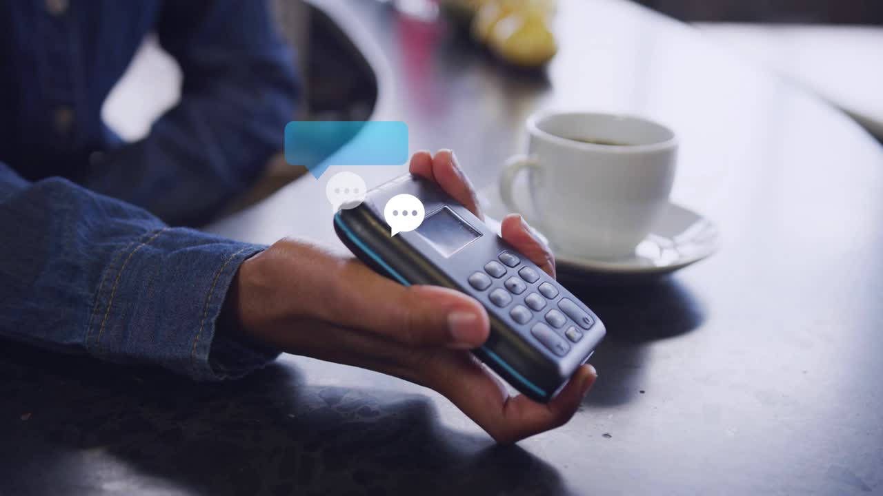 Cashier holding terminal and rotating it while customer tapping card, sparking payment chat bubbles
