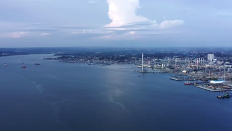 panorama of seaport and oil refinery on the coast of borneo in balikpapan, indonesia