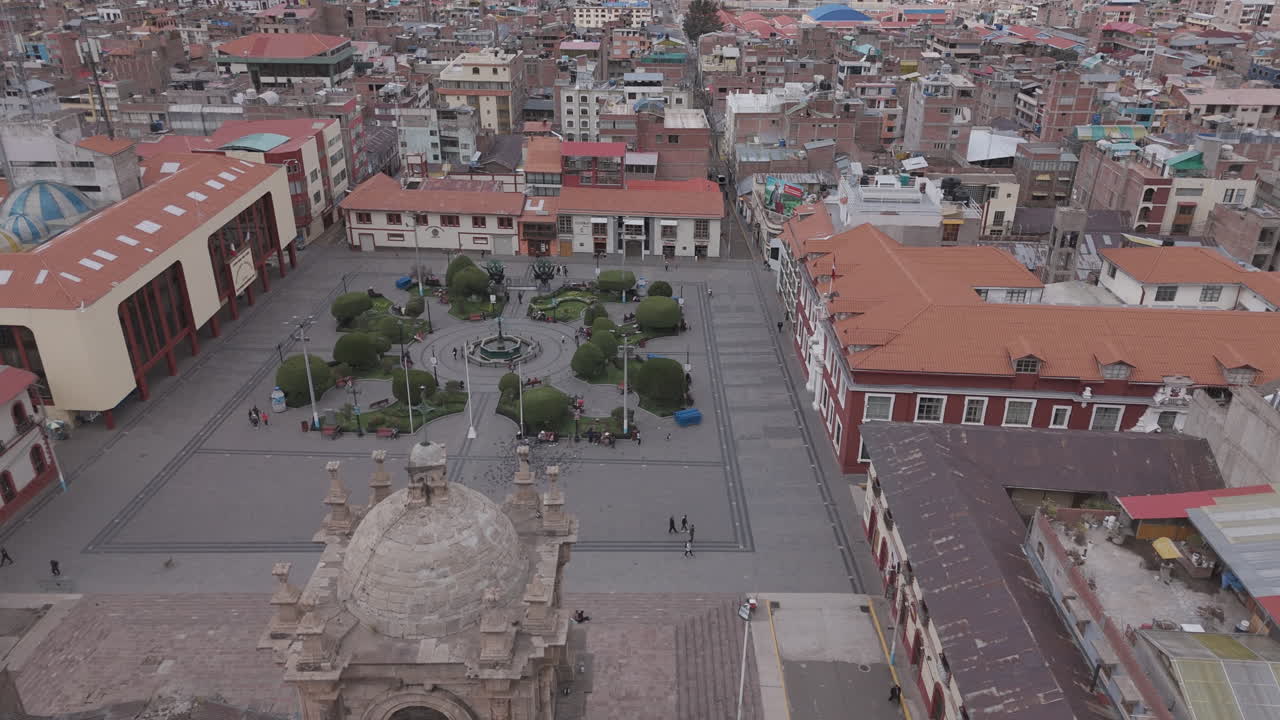 Drone shot above Plaza Mayor de Puno Peru near the church or cathedral LOG