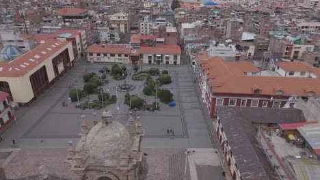drone shot above plaza mayor de puno peru near the church or cathedral log