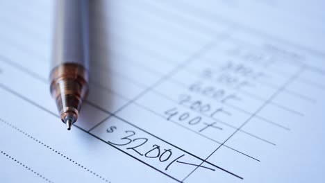 a man writes payment due in a paper form