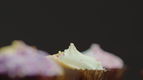 close up shot of sugary cupcakes orbiting around a central cupcake