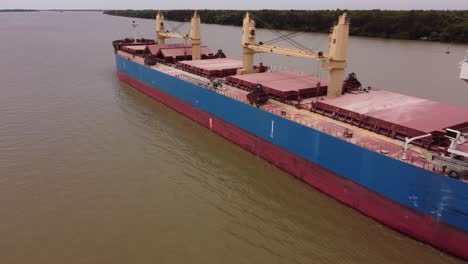 Aerial-view-of-old-Big-Bulk-Carrier-cargo-ship-cruising-on-Parana-River-in-Argentina