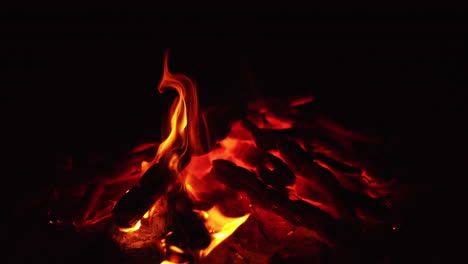 burned out wood in the bonfire. beautiful smoldering embers in a pile. close up.
