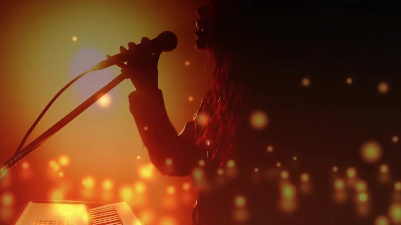 Musician playing keys, hand reaching mic then singing, orange backlight and bokeh overlaying shot